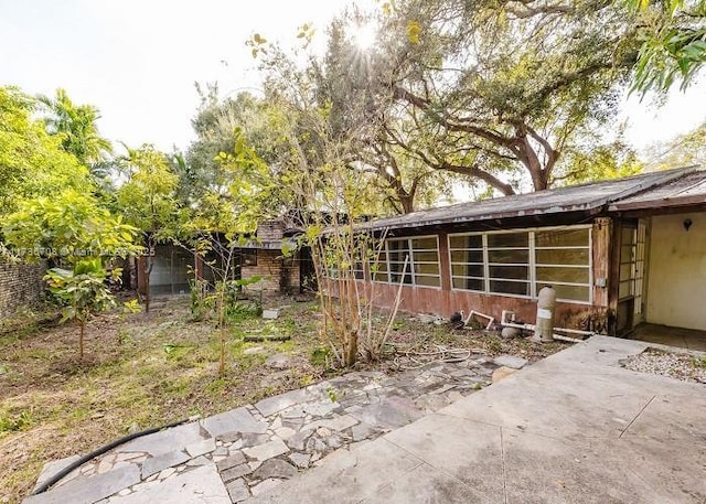 view of side of home with a patio area