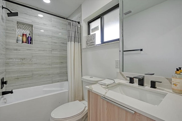 full bathroom with shower / tub combo with curtain, vanity, and toilet