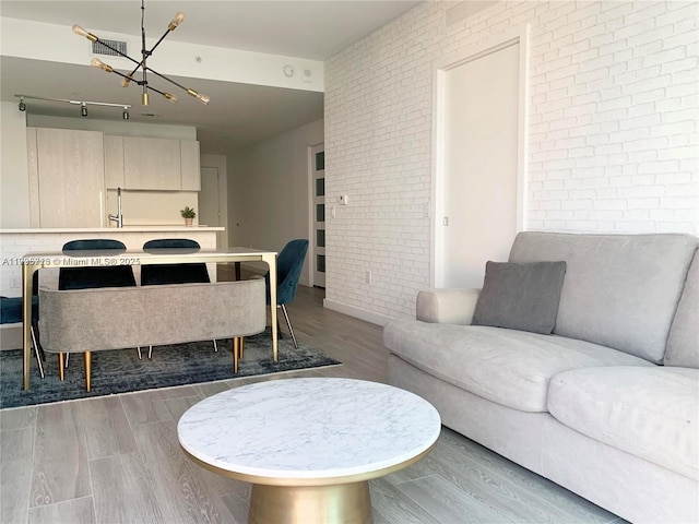 living room with wood-type flooring and brick wall