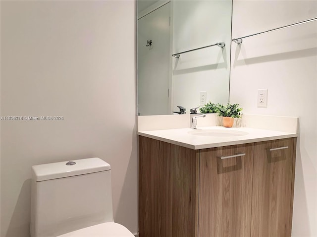 bathroom featuring vanity and toilet