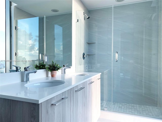 bathroom featuring vanity and an enclosed shower