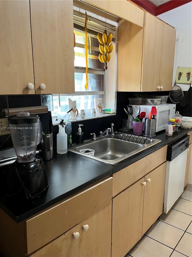 kitchen with dishwasher, sink, and light tile patterned flooring