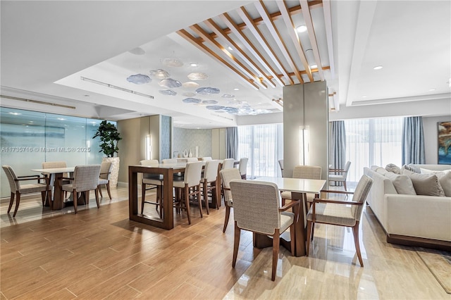 dining area featuring light hardwood / wood-style floors and a healthy amount of sunlight