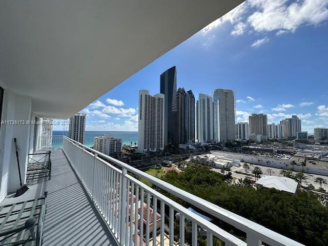 balcony featuring a water view and central AC unit