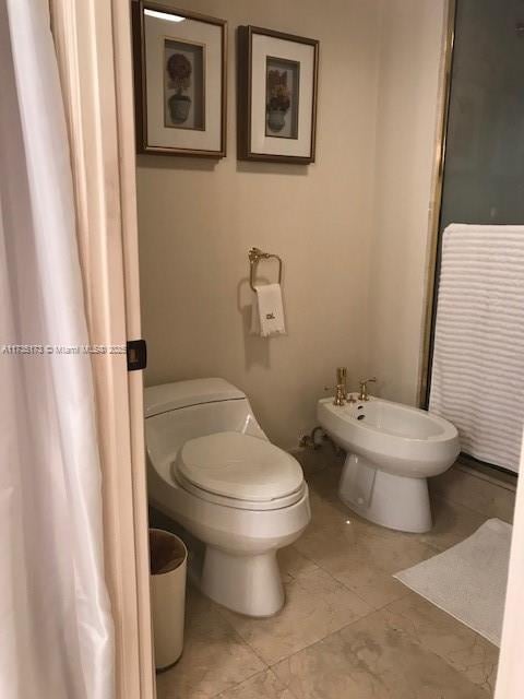 bathroom featuring toilet and a bidet