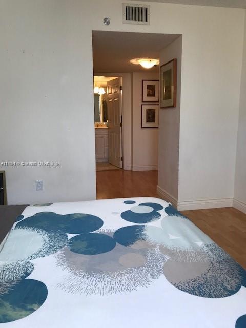 bedroom featuring visible vents and baseboards