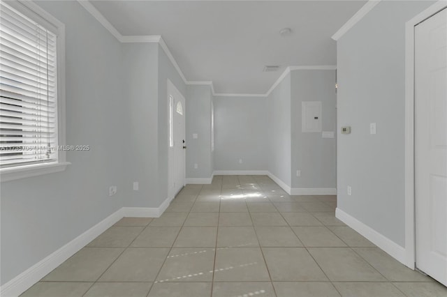 spare room with crown molding and light tile patterned flooring