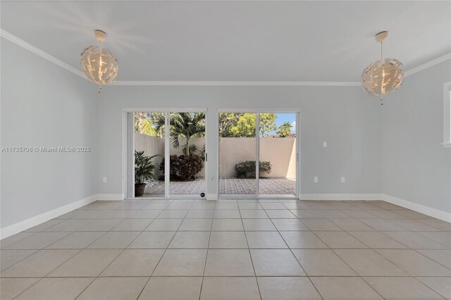 tiled spare room with an inviting chandelier, crown molding, and a healthy amount of sunlight