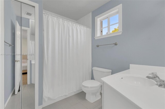 bathroom with tile patterned floors, vanity, and toilet