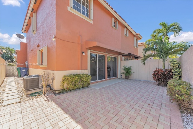 rear view of house with a patio and central AC