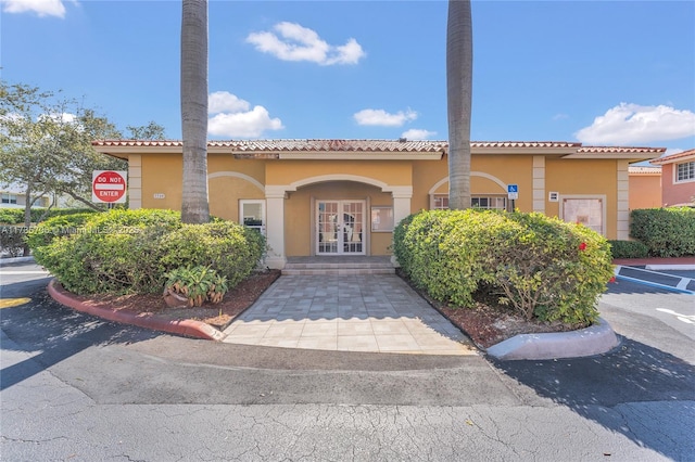 mediterranean / spanish-style home with french doors