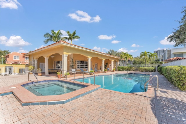 view of pool with a hot tub, a patio, and ceiling fan