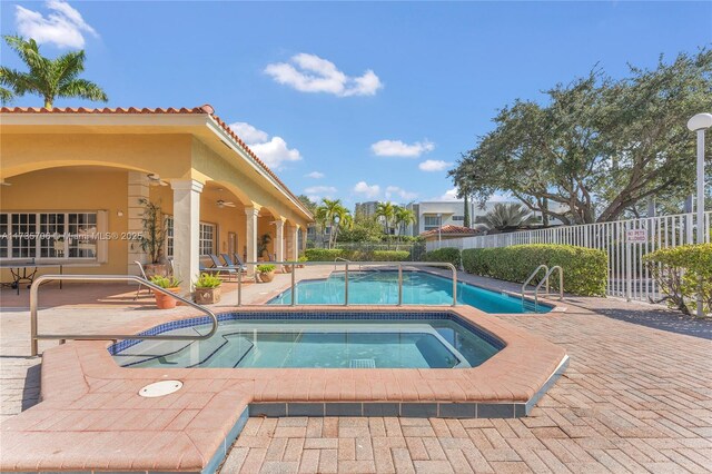 view of swimming pool with an in ground hot tub, ceiling fan, and a patio