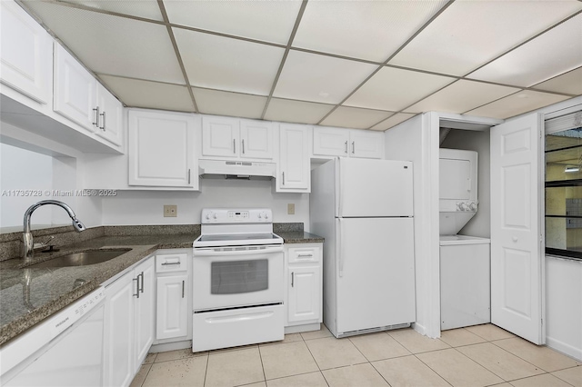 6575 W Oakland Park Blvd Unit 114, Lauderhill, FL 33313 - kitchen with white appliances, stacked washer / dryer, under cabinet range hood, white cabinetry, and a drop ceiling