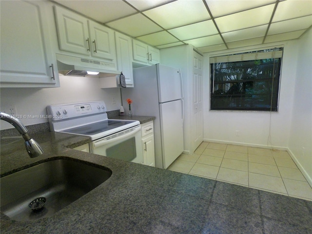 kitchen with sink, white appliances, a paneled ceiling, white cabinets, and light tile patterned flooring