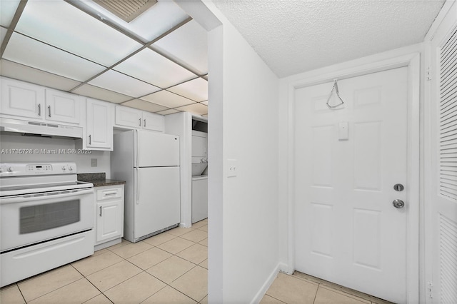 6575 W Oakland Park Blvd Unit 114, Lauderhill, FL 33313 - kitchen with white appliances, under cabinet range hood, light tile patterned floors, dark countertops, and white cabinets