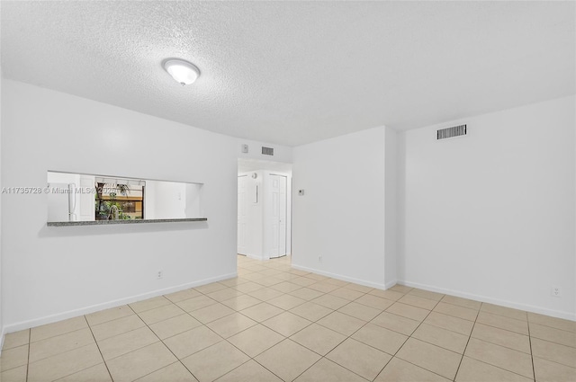 6575 W Oakland Park Blvd Unit 114, Lauderhill, FL 33313 - empty room featuring a textured ceiling and tile patterned floors