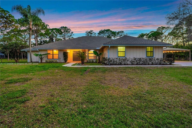 single story home with a lawn and a carport