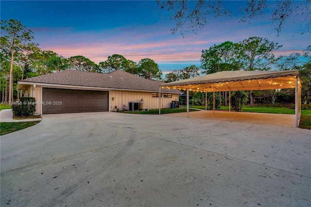 view of front of home featuring a garage and central AC unit