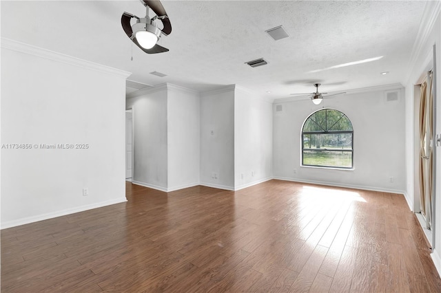 spare room with crown molding, dark hardwood / wood-style flooring, and a textured ceiling