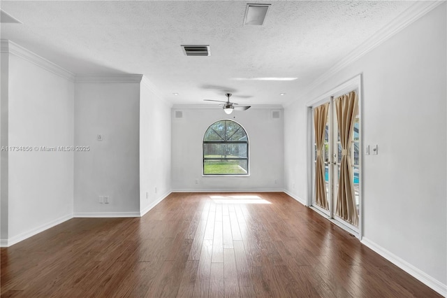 spare room with dark hardwood / wood-style flooring, ceiling fan, ornamental molding, and a textured ceiling