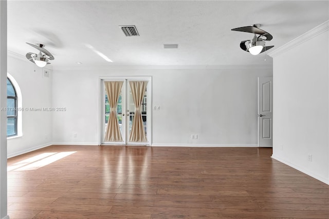 empty room with crown molding, ceiling fan, dark hardwood / wood-style floors, and a textured ceiling