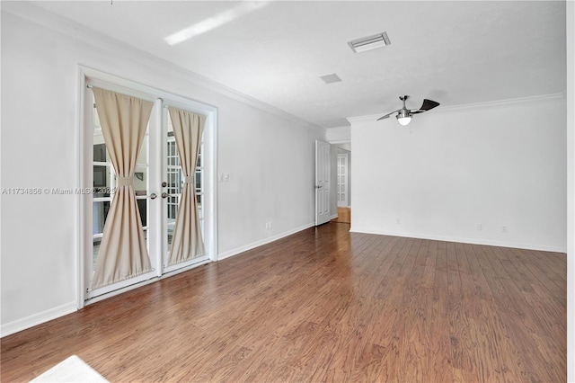 empty room featuring ornamental molding, hardwood / wood-style floors, and ceiling fan