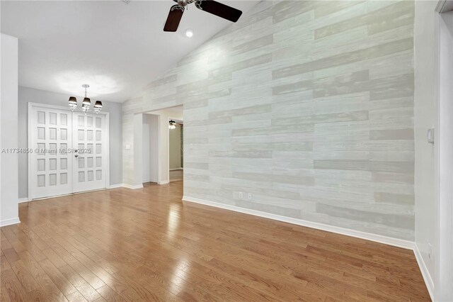 13230 N 153rd Rd N, Jupiter, FL 33478 - unfurnished room featuring lofted ceiling, a chandelier, a ceiling fan, wood finished floors, and baseboards