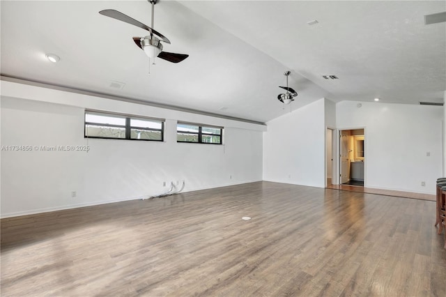 spare room with lofted ceiling, wood-type flooring, and ceiling fan