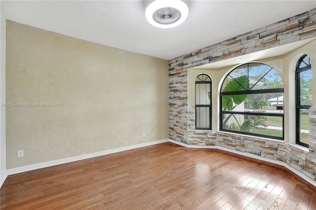 spare room with hardwood / wood-style flooring