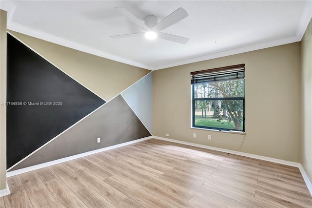 spare room featuring ceiling fan, ornamental molding, and light wood-type flooring