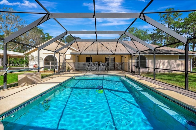 view of swimming pool with a patio and glass enclosure