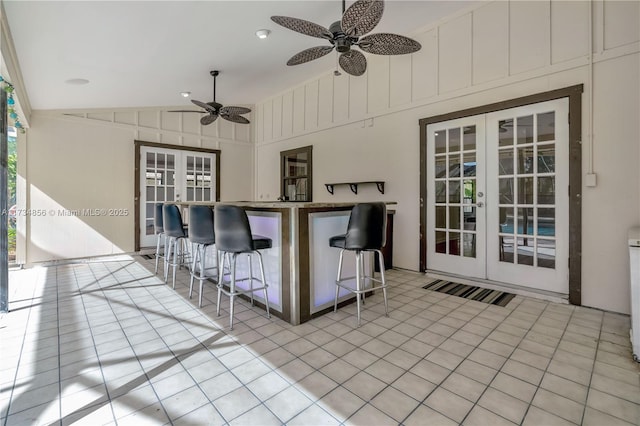 view of patio featuring an outdoor bar, ceiling fan, and french doors