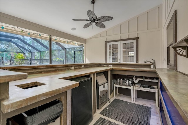 kitchen with fridge, ceiling fan, sink, and vaulted ceiling