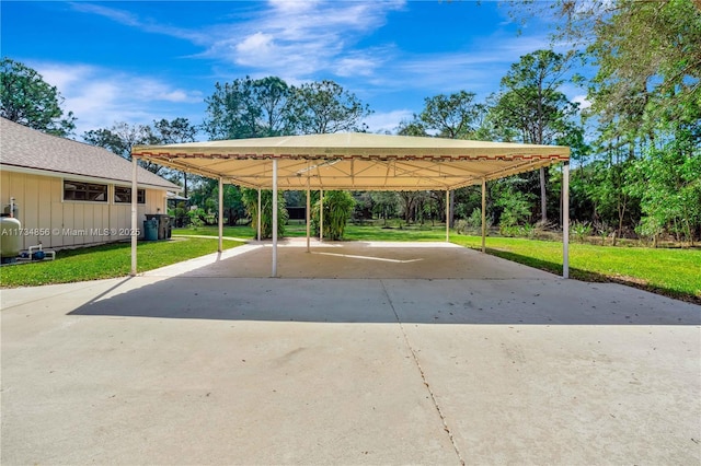 view of vehicle parking featuring a carport and a yard