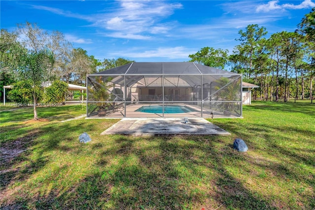 view of swimming pool featuring a lanai, a yard, and a patio area