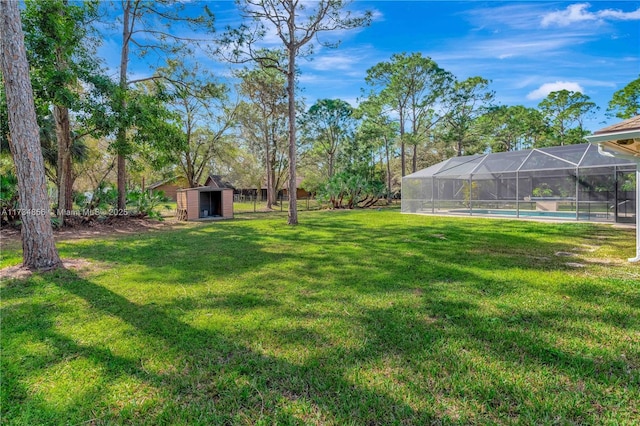 view of yard featuring a lanai and a shed