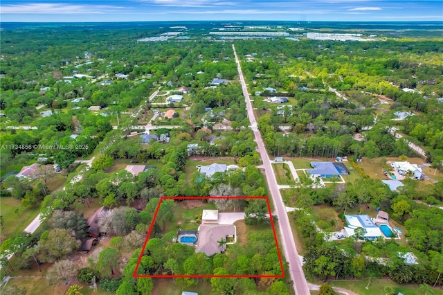 13230 N 153rd Rd N, Jupiter, FL 33478 - aerial view of property and surrounding area with property parcel outlined and a heavily wooded area
