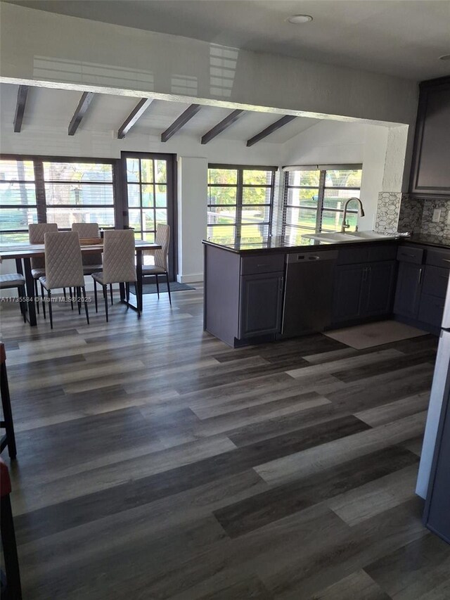 kitchen featuring backsplash, dark wood-type flooring, gray cabinets, and appliances with stainless steel finishes