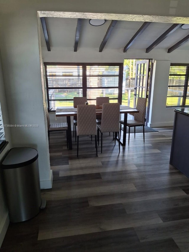 dining area with dark wood-type flooring and lofted ceiling with beams