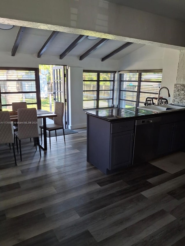 kitchen with lofted ceiling with beams, sink, a wealth of natural light, and dark hardwood / wood-style flooring