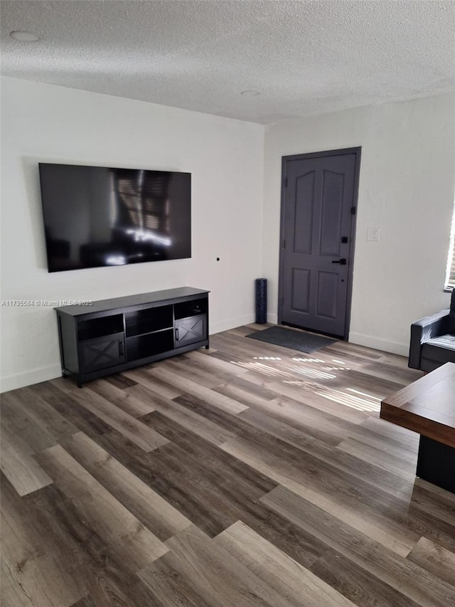 living room featuring hardwood / wood-style flooring and a textured ceiling