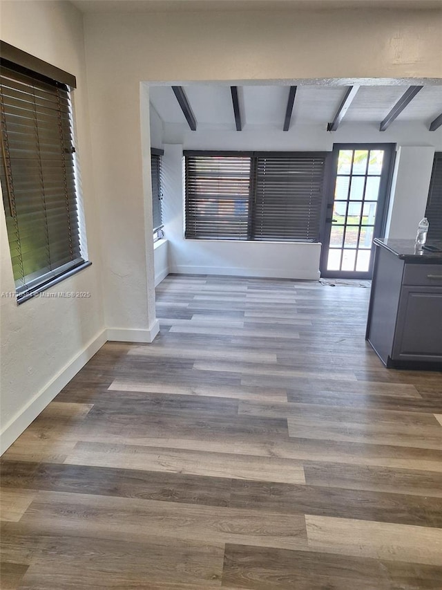 hall with hardwood / wood-style flooring and beam ceiling