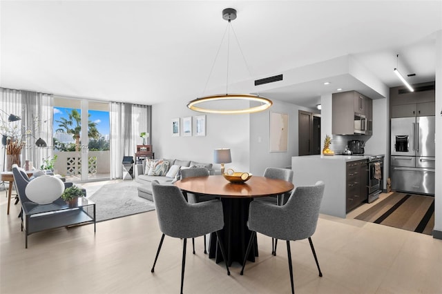 dining area featuring a wall of windows