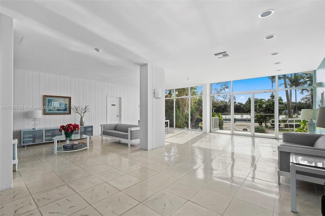 tiled living room featuring expansive windows