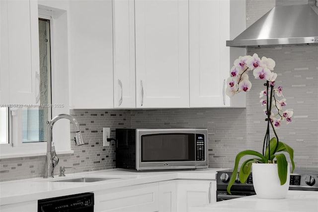 kitchen with sink, white cabinetry, range with electric stovetop, black dishwasher, and wall chimney range hood