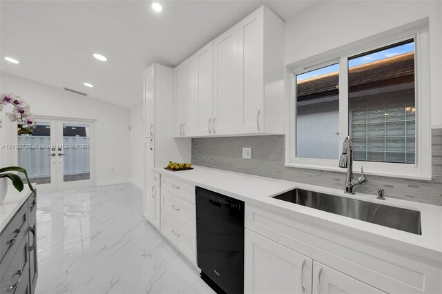 kitchen with black dishwasher, sink, white cabinets, backsplash, and french doors