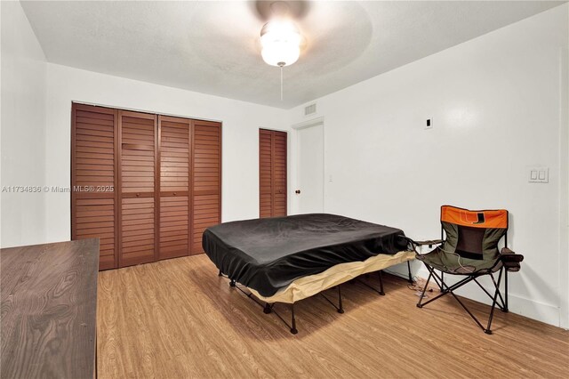 bathroom with wood-type flooring and radiator heating unit