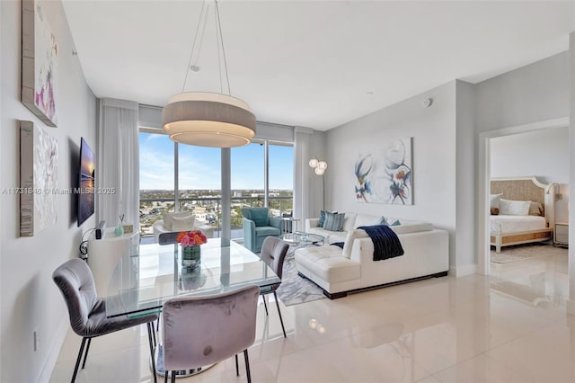 dining area featuring light tile patterned floors and floor to ceiling windows