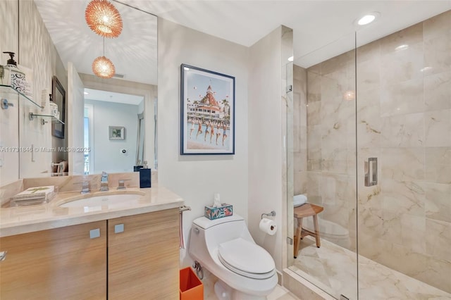 bathroom featuring an enclosed shower, vanity, and toilet